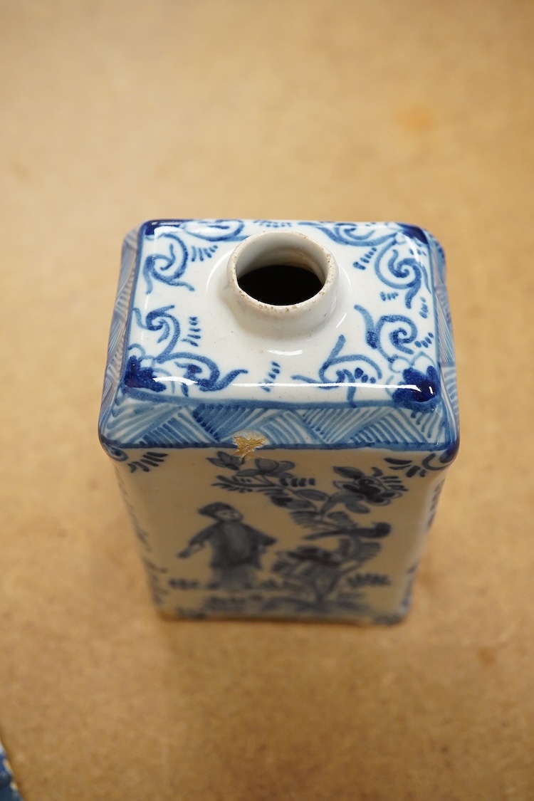 An 18th century Delft tea caddy decorated with figures and flowers and tile, 13cm square